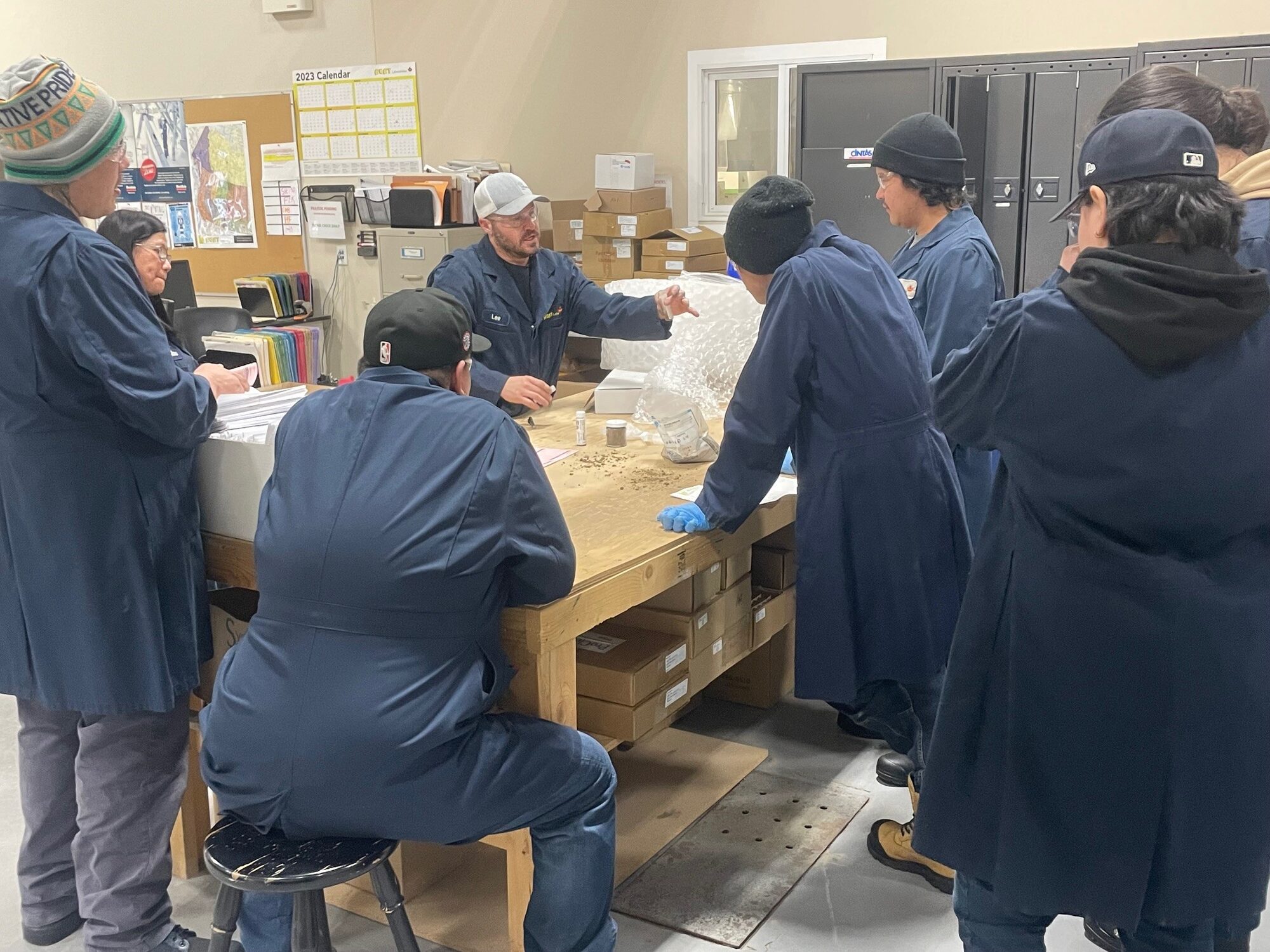 Students working together at tables in a college workshop