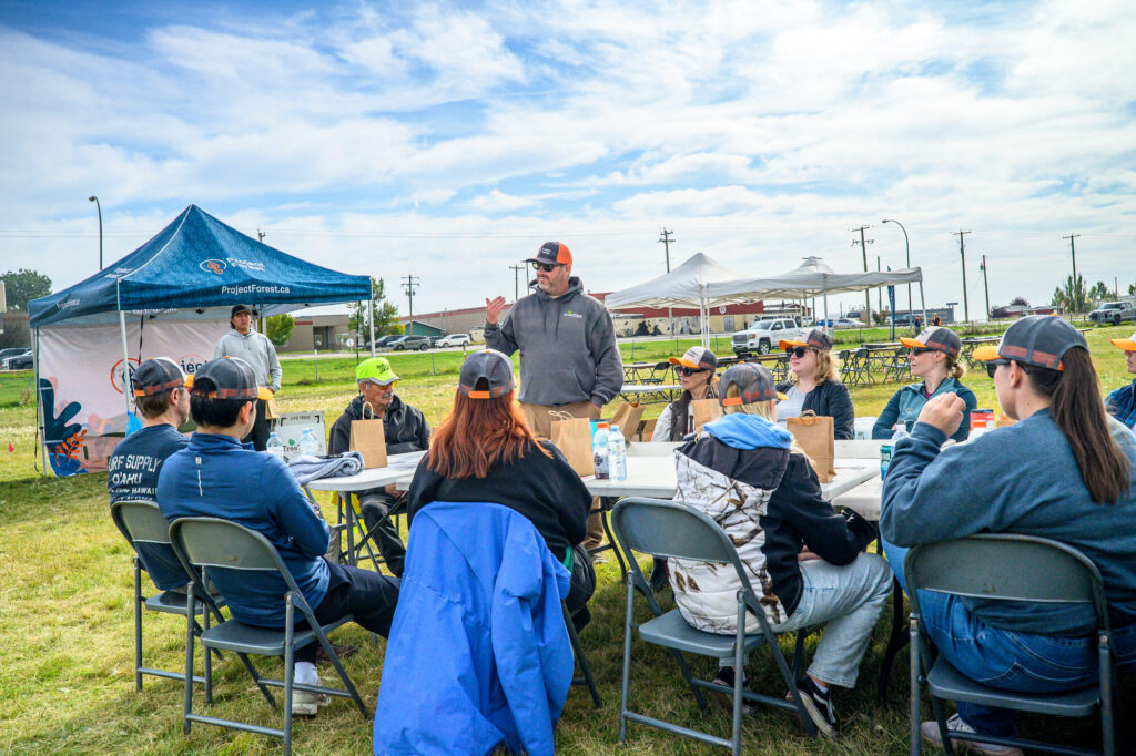 Volunteers sharing a catered lunch under a tent