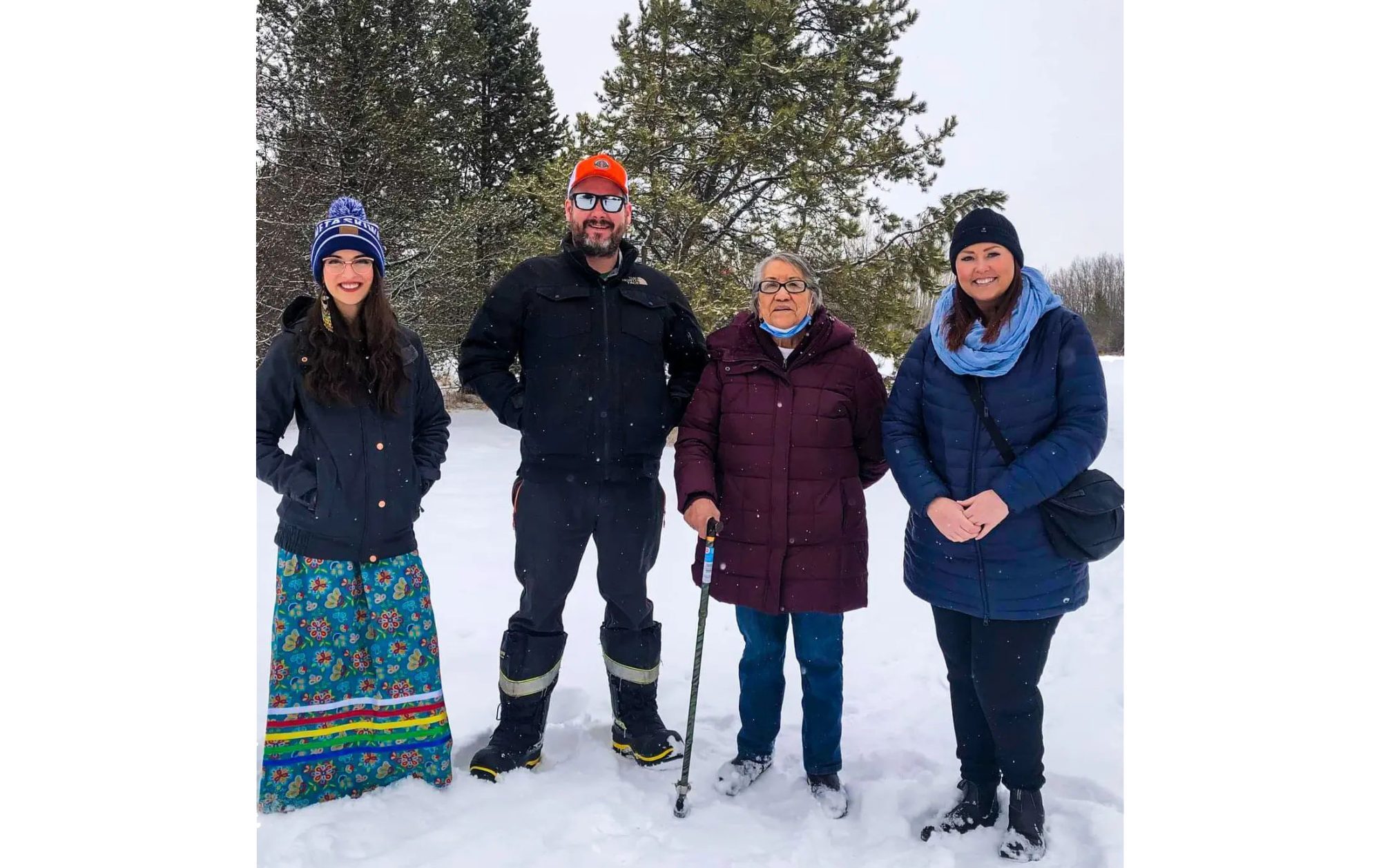 Four people stand together in the snow at the Ma Matow Sakow site